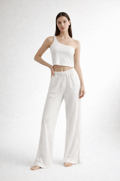 White one-shoulder cropped top and wide-leg trousers set