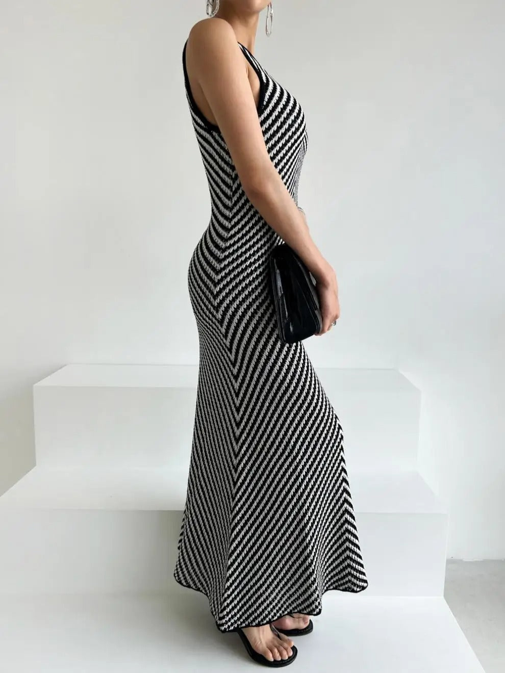 Black and white striped sleeveless maxi dress with high neckline