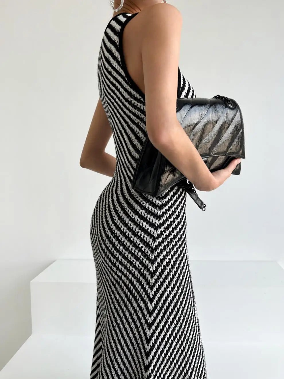 Black and white striped sleeveless maxi dress with high neckline
