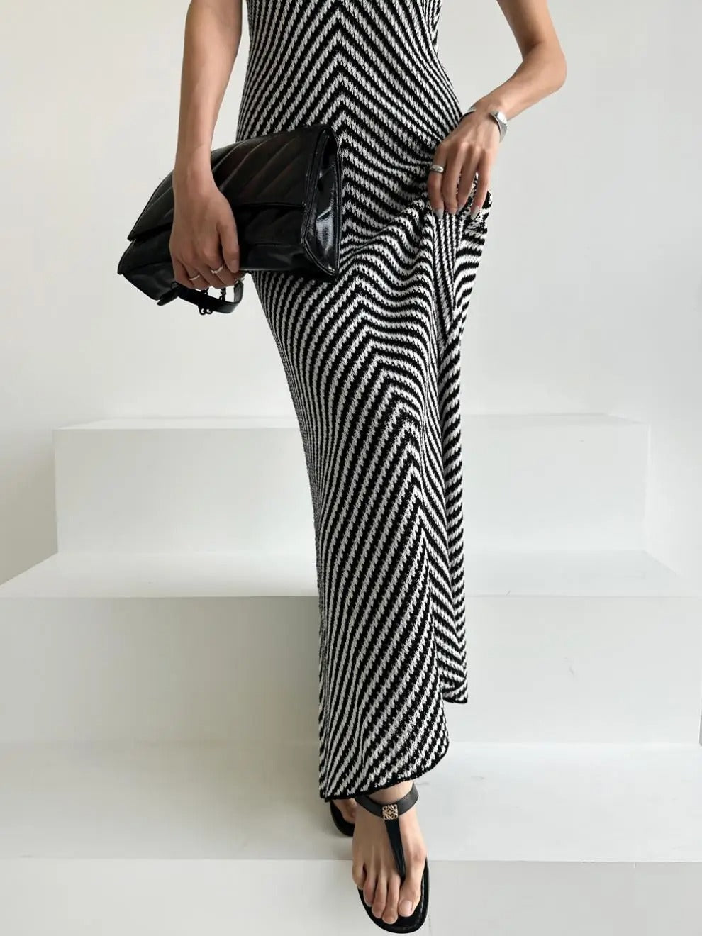 Black and white striped sleeveless maxi dress with high neckline