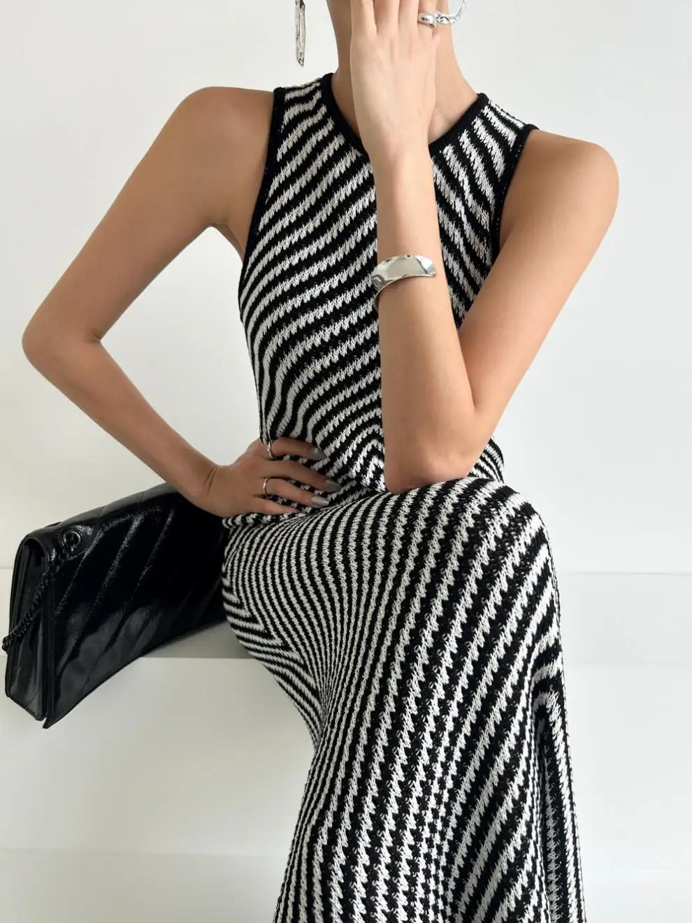 Black and white striped sleeveless maxi dress with high neckline