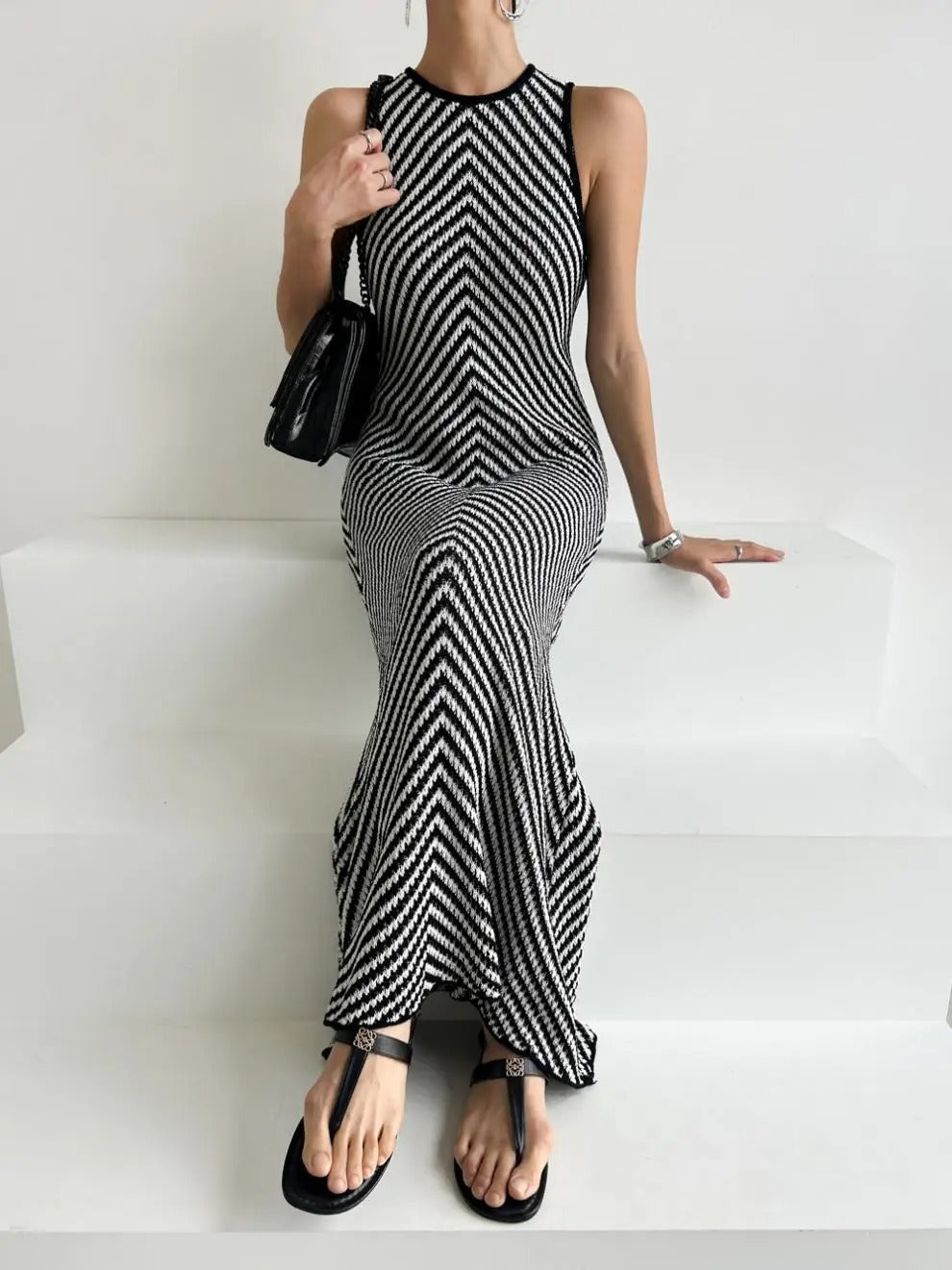 Black and white striped sleeveless maxi dress with high neckline