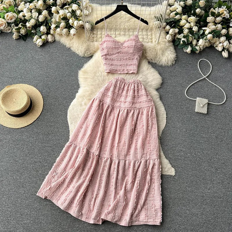 Light pink two-piece set with smocked top and tiered skirt